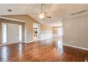 Spacious living room featuring gleaming hardwood floors, neutral paint, and lots of natural light at 12384 Riviera Dr, Fayetteville, GA 30215
