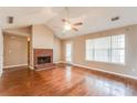 Comfortable living room boasts a cozy brick fireplace, ceiling fan and backyard access at 12384 Riviera Dr, Fayetteville, GA 30215