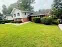 Charming two-story home with a brick-and-siding exterior and well-manicured landscaping at 3755 Greentree Dr, Decatur, GA 30032