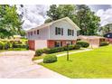 Exterior side view of a charming home with a well-manicured lawn and attached garage at 3755 Greentree Dr, Decatur, GA 30032