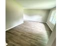 Open-concept living room with wood-look flooring and abundant natural light at 3755 Greentree Dr, Decatur, GA 30032