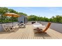 Expansive rooftop deck with cozy hammock, outdoor dining setup, and shaded retreat at 417 E College Ave # 302, Decatur, GA 30030