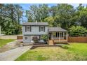 Charming two-story home with a welcoming front porch and nicely landscaped yard at 4835 Kellys Mill Nw Dr, Lilburn, GA 30047