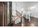 Welcoming foyer featuring wood floors and staircase leading to the upper level at 4835 Kellys Mill Nw Dr, Lilburn, GA 30047