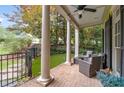 Covered brick front porch with outdoor furniture and decorative columns, perfect for relaxing outdoors at 635 Holcomb Bridge Rd, Norcross, GA 30071