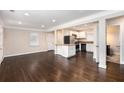 Open concept living area featuring hardwood floors, and granite countertops into the kitchen at 1856 Austell Sw Cir, Marietta, GA 30060