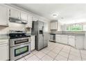Bright kitchen with stainless appliances, white cabinets, and granite countertops at 3227 Ivy Lake Ct, Buford, GA 30519