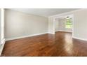 Elegant living room featuring beautiful hardwood floors, natural light, and neutral paint at 3227 Ivy Lake Ct, Buford, GA 30519