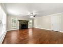 Spacious living room with a fireplace, hardwood floors, and neutral paint at 3227 Ivy Lake Ct, Buford, GA 30519