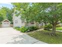 This is a charming home featuring a detached garage, beautiful landscaping, and a welcoming front porch at 3404 Orchard St, Hapeville, GA 30354