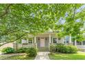 Charming home featuring a welcoming porch and mature trees in a picturesque setting at 3404 Orchard St, Hapeville, GA 30354