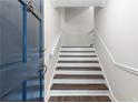 Welcoming entryway with hardwood stairs, blue door, and a view of the upper level at 433 The North Chace, Atlanta, GA 30328