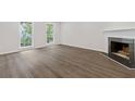Bright living room featuring hardwood floors, a classic fireplace, and ample natural light at 433 The North Chace, Atlanta, GA 30328