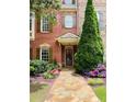 Attractive brick home featuring a stone path and vibrant landscaping leading to the entrance at 578 Parkside Village Nw Way, Marietta, GA 30060