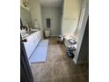 Bright bathroom with double sinks, tiled floors, and a garden tub for relaxation at 1400 Land Rd, Canton, GA 30114