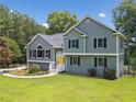 Beautiful gray two-story home with black shutters and a well-manicured lawn at 1400 Land Rd, Canton, GA 30114