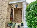 Inviting front porch with decorative plants and a hanging planter, creating a warm welcome at 3534 Clancy Way, Smyrna, GA 30080