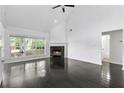 Bright living room featuring a fireplace, ceiling fan, and large windows for ample natural light at 4042 Laurel Bend Ct, Snellville, GA 30039