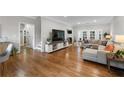 Bright and airy living room featuring hardwood floors and a cozy seating area with natural light at 10880 Windham Way, Alpharetta, GA 30022