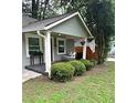 The inviting front porch features a swing, a small accent table and neatly trimmed landscaping at 1341 Se Joyner Se Ave, Marietta, GA 30060