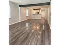 Open-concept living room featuring wood-look floors, neutral paint and a dark accent beam in the ceiling at 1341 Se Joyner Se Ave, Marietta, GA 30060
