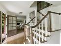 Elegant staircase with wood and white trim, leading to the upper level, with open view of the front door at 2973 Payton Ne Rd, Atlanta, GA 30345