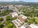 Expansive aerial view showcases the building's location within a lush, green landscape with mountain backdrop at 326 Roswell Se St # 406, Marietta, GA 30060