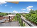 Balcony with metal railing offering a scenic view of mature trees and the surrounding neighborhood at 326 Roswell Se St # 406, Marietta, GA 30060