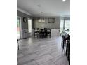 Open-concept dining room showcases tiled floors, modern lighting, and seamless access to outdoor patio at 3560 Elinburg Dr, Buford, GA 30519