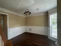 Elegant dining room features hardwood floors, decorative trim, and a stylish chandelier at 4189 Duncan Ives Dr, Buford, GA 30519
