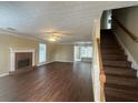 Spacious living room boasts a brick fireplace, hardwood floors, and plenty of natural light at 4189 Duncan Ives Dr, Buford, GA 30519