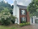 This home features traditional brick architecture, complemented by lush greenery and mature trees at 4189 Duncan Ives Dr, Buford, GA 30519