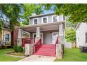 Beautiful gray home featuring a welcoming front porch with stone accents and lush green lawn at 641 Ira Sw St, Atlanta, GA 30312