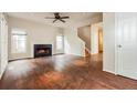Spacious living room featuring a cozy fireplace, large windows, and hardwood floors at 641 Ira Sw St, Atlanta, GA 30312