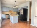 Spacious kitchen with stainless steel appliances, an island, and attractive flooring at 795 Abbotts Mill Ct # 73, Johns Creek, GA 30097