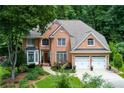 Beautiful brick two-story home featuring an attached two-car garage and green lawn at 3245 Bywater Trl, Roswell, GA 30075