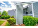 Stylish condo exterior exhibits manicured shrubbery, green siding, and welcoming entry at 325 Berry Ct, Villa Rica, GA 30180