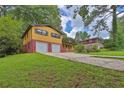 Charming two-story home with brick and siding, featuring an attached two-car garage and a well-maintained front yard at 4246 Rue Saint Michel, Stone Mountain, GA 30083