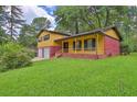 Charming two-story home with brick and siding, featuring an attached two-car garage and a well-maintained front yard at 4246 Rue Saint Michel, Stone Mountain, GA 30083