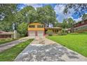 Charming two-story home with brick and siding, featuring an attached two-car garage and a well-maintained front yard at 4246 Rue Saint Michel, Stone Mountain, GA 30083