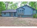 The back of the house shows a patio and siding on this two-story home surrounded by green foliage at 2685 Peachtree Walk Walk, Duluth, GA 30096