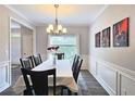 Elegant dining room featuring a chandelier, wainscoting, and a dining set, creating an inviting space at 3152 Andora Sw Trl, Marietta, GA 30064