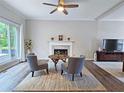 Cozy living room with fireplace, ceiling fan, hardwood floors, large windows and neutral decor at 3152 Andora Sw Trl, Marietta, GA 30064