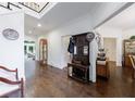 Spacious hallway featuring hardwood floors, antique decor, and access to multiple rooms at 525 Avala Ct, Johns Creek, GA 30022