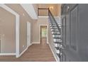 Inviting foyer with wood floors, a wrought iron staircase, and neutral paint that complements natural light at 5705 Cannonero Dr Dr, Alpharetta, GA 30005