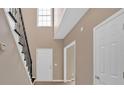 Inviting foyer with wood floors, a wrought iron staircase, and neutral paint that complements natural light at 5705 Cannonero Dr Dr, Alpharetta, GA 30005