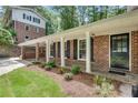 Charming brick home featuring a covered entry, front porch, and well-manicured lawn at 2689 Cosmos Ne Dr, Atlanta, GA 30345
