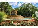 Elegant stone entrance sign for the 'Edgewater' community, surrounded by beautiful landscaping and flowers at 218 Oakmoor Ct, Lawrenceville, GA 30043