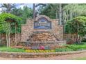 Stone entrance sign with water feature and beautiful flower bed at Edgewater community at 218 Oakmoor Ct, Lawrenceville, GA 30043