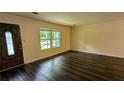 Inviting living room with hardwood floors, neutral walls, and ample natural light at 5177 Mccarter Sta, Stone Mountain, GA 30088